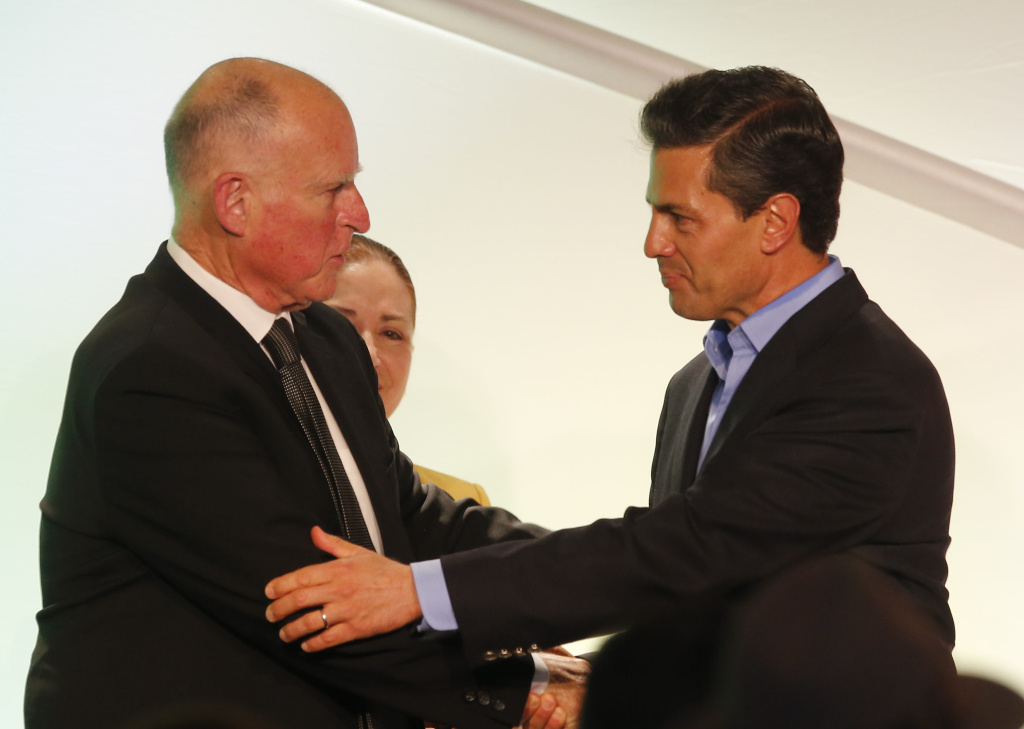Mexico President-California Visit California Gov. Jerry Brown, left, greets Mexico's President Enrique Pena Nieto during a meeting with Mexican-American community leaders and others in Los Angeles, Monday, Aug. 25, 2014. (AP Photo/Damian Dovarganes)