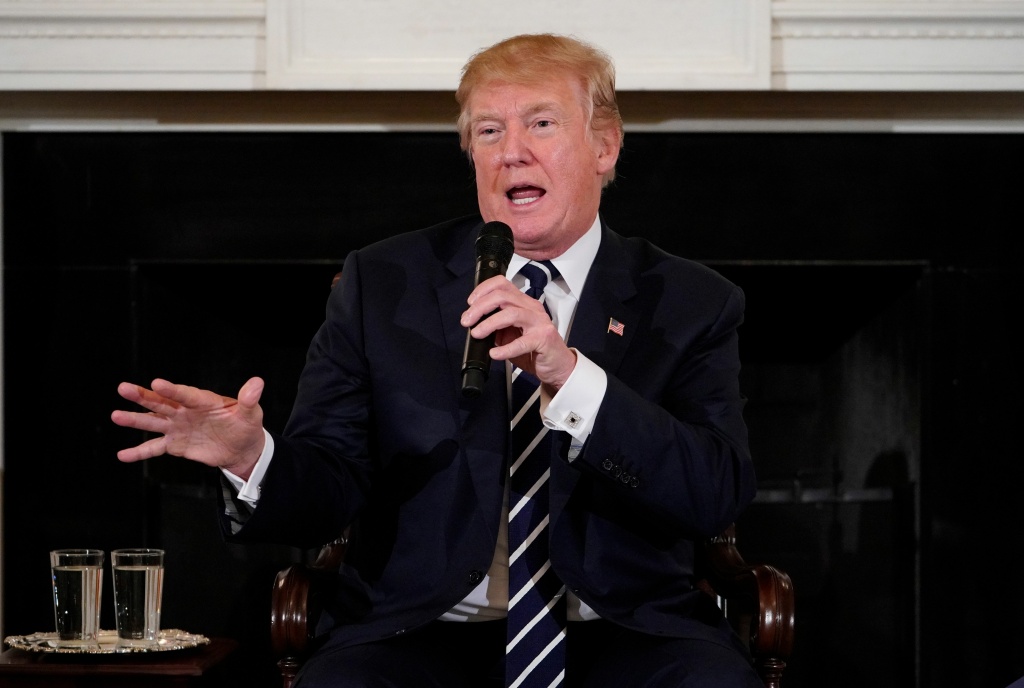 US-POLITICS-TRUMP-SHOOTING US President Donald Trump takes part in a listening session on gun violence with teachers and students in the State Dining Room of the White House on February 21, 2018.