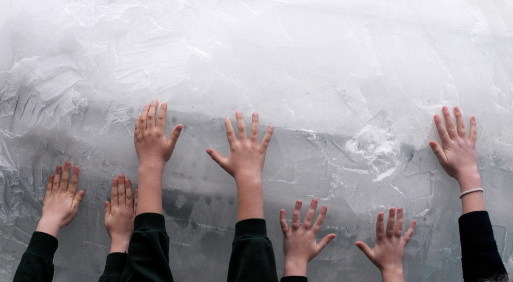 Children place their hands on a life siz Children place their hands on a life size ice carving of a polar bear by animal sculptor Mark Coreth in Trafalgar Square, central London, on December 11, 2009. The sculpture was part of a campaign by the World Wildlife Fund (WWF) to highlight the plight of the polar bears in the Arctic, where melting ice is threatening their survival. EU nations are set to give more than six billion euros (nine billion dollars) to help the developing world tackle climate change in the next three years, British Prime Minister Gordon Brown said Friday.
