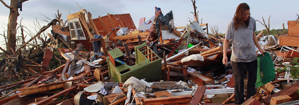 Lacy Tasker salvages what she can from her mothers house after it was destroyed when a massive tornado passed through the town on May 24, 2011 in Joplin, Missouri.