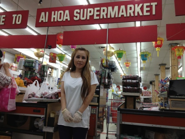 Chinatown residents wait for the bus outside the site of a new neighborhood market from Walmart on the edge of Chinatown at Grand and Cesar Chavez avenues.