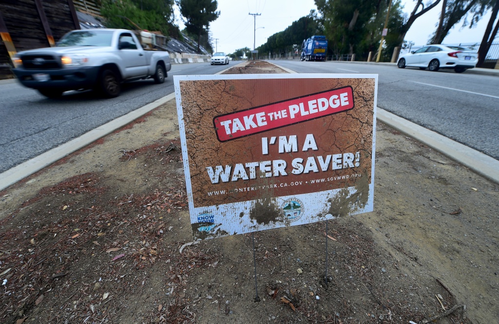US-CALIFORNIA-DROUGHT A water conservation sign remains in what was once a grass-covered traffic divider in Monterey Park, California on May 19, 2016.