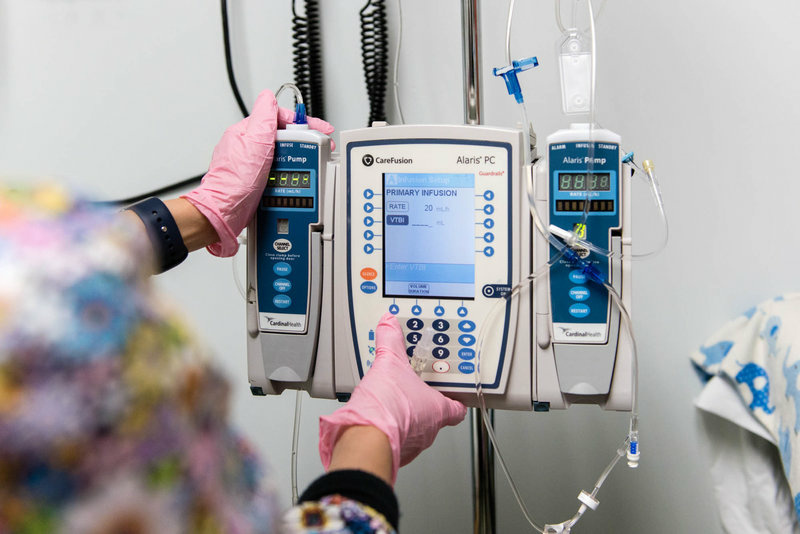 The nurse programs a pump to administer Luke Whitbeck's enzyme-replacement therapy in October 2016. The nurse programs a pump to administer Luke Whitbeck's enzyme-replacement therapy in October 2016.
