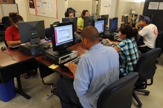 Mercer 13346 Unemployed people search for jobs in an employment office in the southern Californian town of El Centro.