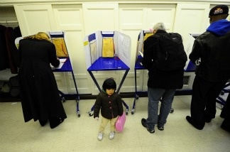 New York residents cast their vote in the US mid-term elections at a polling station at a school in Harlem in New York, November 2, 2010.