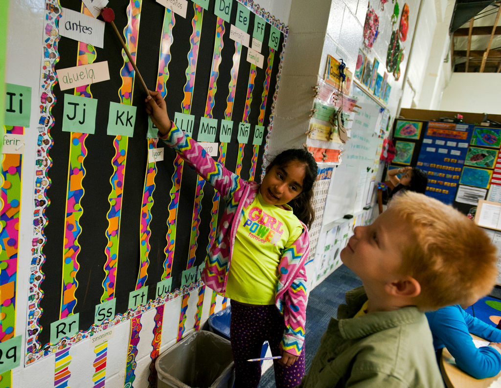 NEWCITYSCHOOL Spanish-primary student Jessica Ortiz helps English-primary student Jack Barnes, both second graders, learn Spanish vocabulary words during the Spanish Language Arts portion.