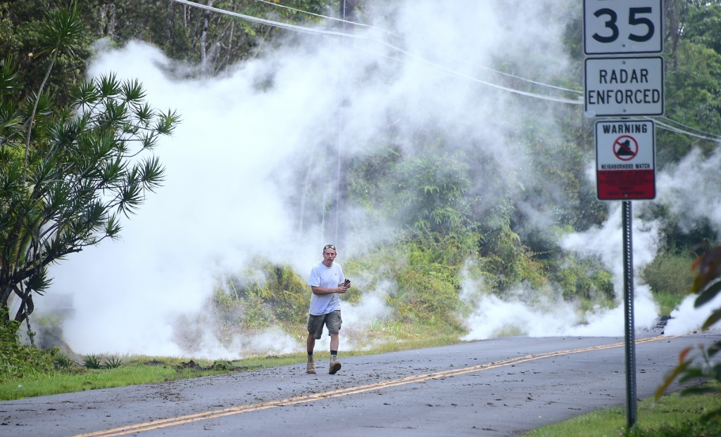 US-VOLCANO-HAWAII A man walks away as steam rises from a fissure at the Leilani Estates subdivision near the town of Pahoa on Hawaii's Big Island on May 4, 2018.