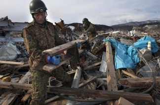 Members of Japan's Self-Defense force clear debris as they continue searching for bodies on March 17, 2011 in Minamisanriku, Japan.