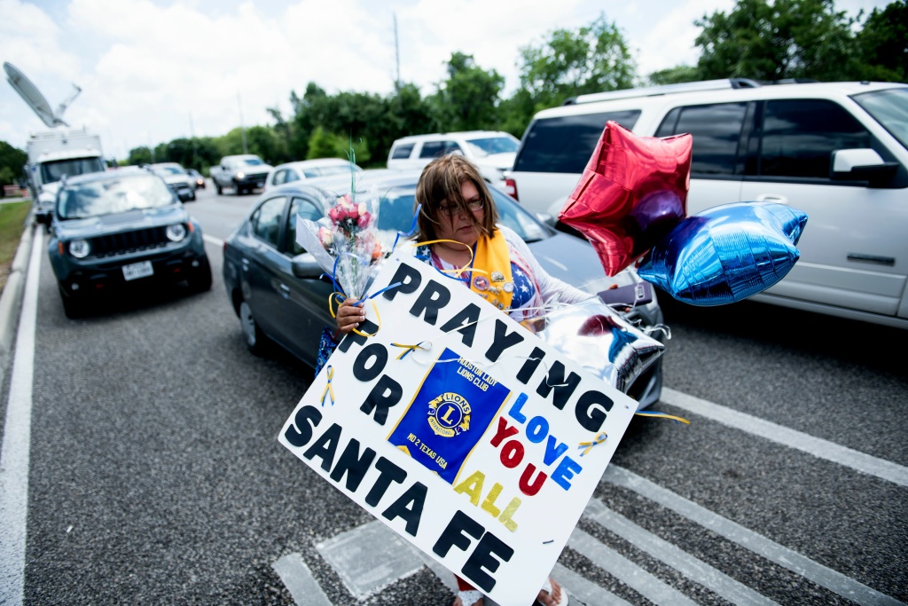 US-CRIME-TEXAS-SCHOOL-SHOOTING Residents bring memorial items to Santa Fe High School on May 19, 2018 in Santa Fe, Texas. Ten people, mostly students, were killed when a teenage classmate armed with a shotgun and a revolver opened fire at the school on May 18.
