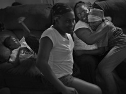 Along with caring for her own children, Jihan Sanders takes care of the children of her best friend, operations specialist Petty Officer 1st Class Sheena Sullen, while Sullen is deployed with the guided missile destroyer USS Mahan. Before bed, Sanders hugs Zaria Sullen-Polk, 8, while Sanders' son Darric, 9, and daughter Tashawn, 12, get ready to say good night.
