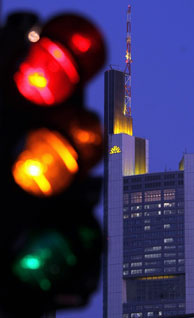 File photo: The headquarters of Germany's Commerzbank AG stands illumilated behind a traffic light on January 9, 2009 in Frankfurt am Main, Germany
