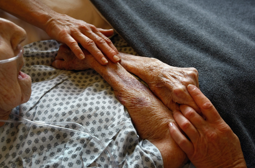Hospice volunteers caress the hands of terminally ill patient Annabelle Martin, 95, as her health quickly declined at the Hospice of Saint John on September 1, 2009 in Lakewood, Colorado. The non-profit hospice, which serves on average 200 people at a time, is the second oldest hospice in the United States. The hospice accepts patients regardless of their ability to pay, although most are covered by Medicare or Medicaid. End of life care has become a contentious issue in the current national debate on health care reform.