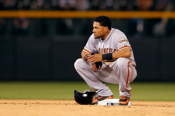 Melky Cabrera of the San Francisco Giants pauses at second base after doubling against the Colorado Rockies at Coors Field on August 3, 2012 in Denver, Colorado.