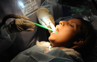A woman receives dental care on the final day that volunteer medical offer free medical, vision and dental services to those without health insurance, during an event sponsored by the Remote Area Medical (RAM) organization in Los Angeles on August 18, 2009.