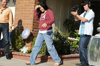 Nadya Suleman, the mother of octuplets, walks outside her new house in La Habra, Calif., for a video crew on March 10, 2009.
