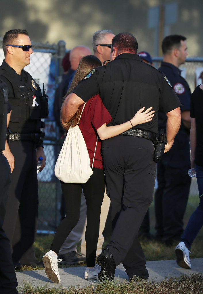 Students Return To Class For First Time After Mass Shooting At Florida School A police officer hugs a student as she arrives for classes at Marjory Stoneman Douglas High School for the first time since the shooting that killed 17 people on February 14 at the school on February 28, 2018 in Parkland, Florida.
