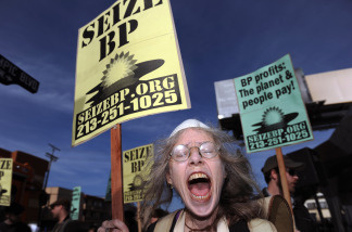 A protester shouts slogans against BP during a demonstration in front of the BP 'Green Curve' Station, in Los Angeles, California, on May 12, 2010. (File photo Gabriel Bouys/AFP/Getty Images)