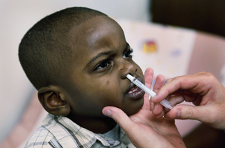 Isiah Harris receives an H1N1 influenza vaccine at Rush University Medical Center October 6, 2009 in Chicago, Illinois. Rush is one of many hospitals and clinics that have started to distribute the vaccinations against the H1N1 swine flu virus in the United States this week.