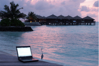 Mercer 8463 Laptop sits on a pier by the shore in the Maldives.