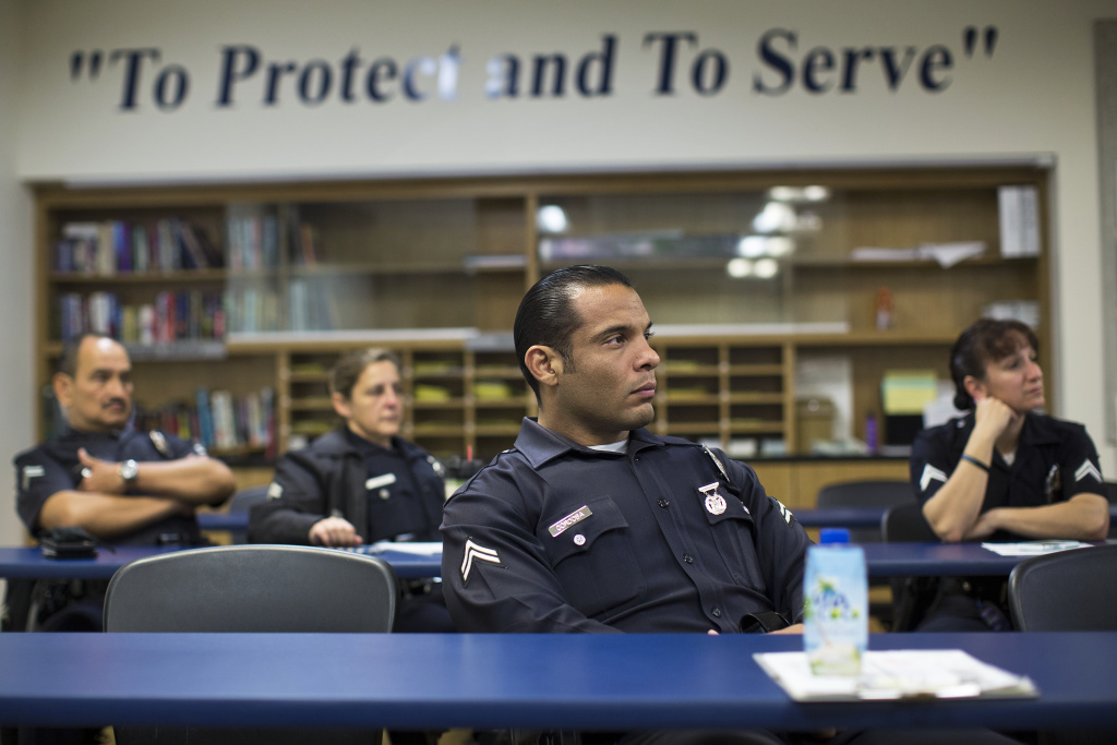 LAPD MEU - SLIDESHOW - 5 Police officers take part in a check-in from LAPD's Mental Evaluation Unit during a roll call on Friday morning, Jan. 16, 2015 at the Topanga Police Department in Canoga Park.