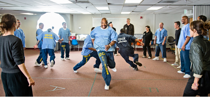 Attorney General Eric Holder watches a performance of the Actor's Gang Prison Project at the California Rehabilitation Center in Norco, California