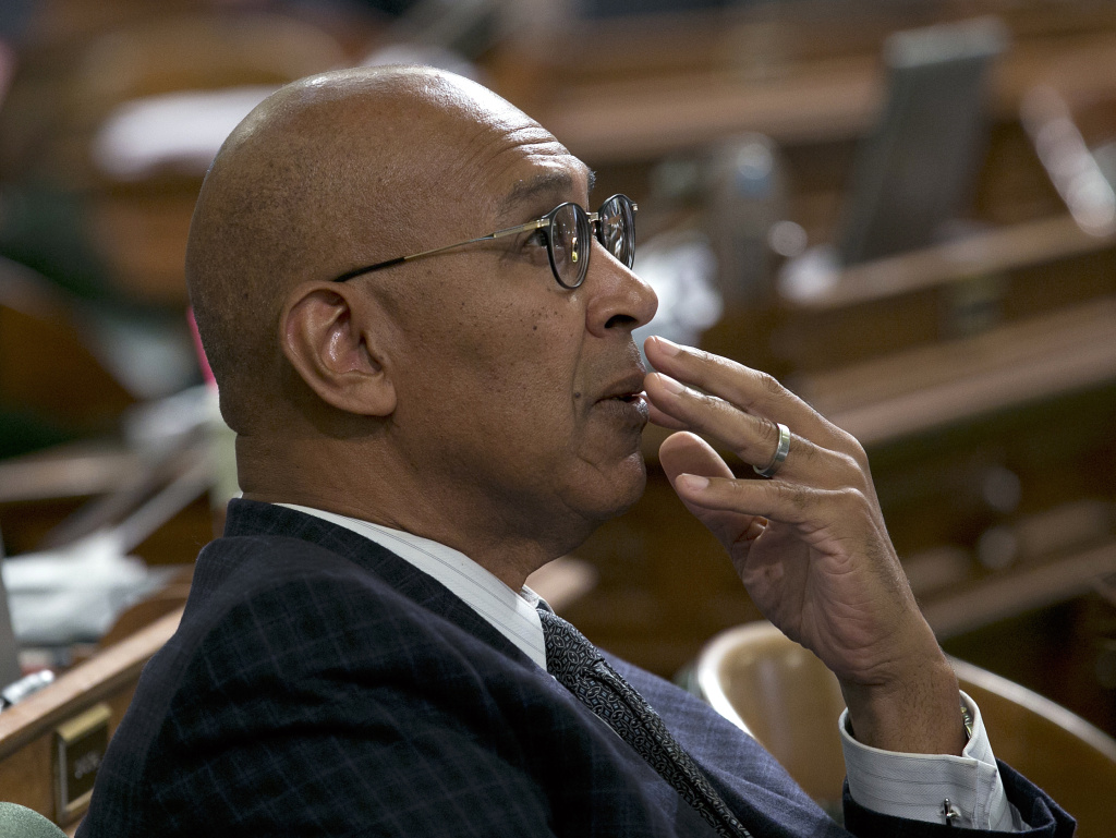 Assemblyman Chris Holden, D-Pasadena, watches as the votes are posted for a measure at the Assembly, Wednesday, Sept. 13, 2017, in Sacramento, Calif. Saying they needed more discussion, Holden withdrew two bills he was sponsoring that would have paved the for merging California's energy ride with others in the West. He hopes to revisit the proposal next year.