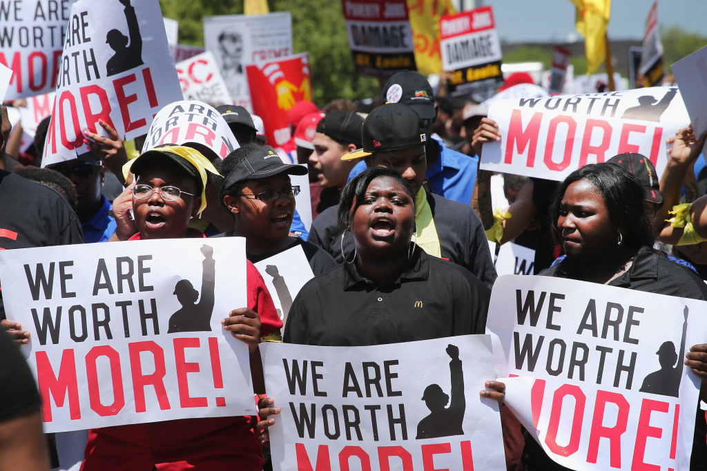 Fast Food Workers Protest For Increased Wages Ahead Of McDonald's Annual Shareholder Meeting Fast food workers and activists demonstrate outside the McDonald's corporate campus on May 21, 2014 in Oak Brook, Illinois. The demonstrators were calling on McDonald's to pay a minimum wage of $15-per-hour and offer better working conditions for their employees. Several protestors were arrested after they entered and ignored police orders to leave the McDonald's campus. McDonald's is scheduled to hold its annual shareholder's meeting tomorrow at the campus.