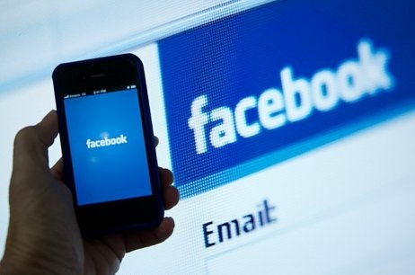 An illustration of an Apple iPhone displaying the Facebook app's splash screen in front of the login page. An illustration of an Apple iPhone displaying the Facebook app's splash screen in front of the login page.