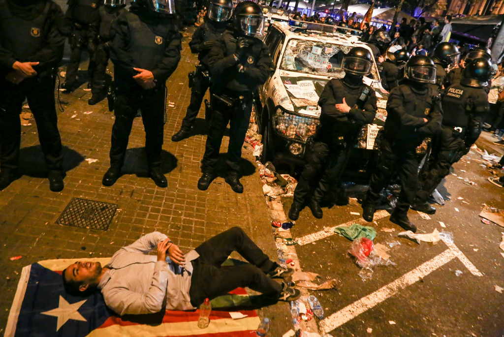 Catalan independence A pro-independence demonstrator lies on a Catalan flag on Sept. 20 in Barcelona.