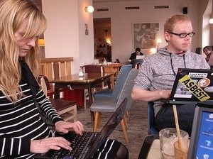 People work on laptops at Sankt Oberholtz cafe in Berlin. People work on laptops at Sankt Oberholtz cafe in Berlin.