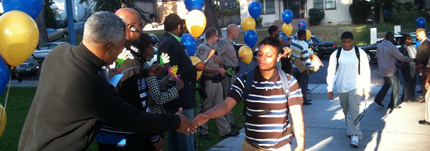 Alumni, civic leaders, administrators and police welcome students at Crenshaw High School on the first day of classes.