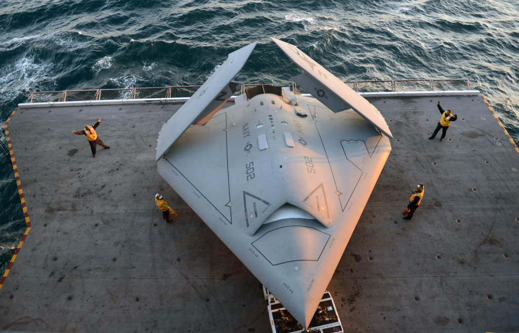 Navy Launches First Drone From Aircraft Carrier Sailors move an X-47B Unmanned Combat Air System (UCAS) demonstrator onto an aircraft elevator aboard the aircraft carrier USS George H.W. Bush (CVN 77) May 14, 2013 in the Atlantic Ocean. George H.W. Bush is scheduled to be the first aircraft carrier to catapult-launch an unmanned aircraft from its flight deck. The Navy plans to have unmanned aircraft on each of its carriers to be used for surveillance and be armed and used in combat roles.