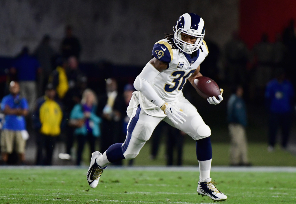 Running back Todd Gurley #30 of the Los Angeles Rams runs with the ball after taking a hand off during the first quarter of the NFC Wild Card Playoff game against the Atlanta Falcons at Los Angeles Coliseum on January 6, 2018 in Los Angeles, California.