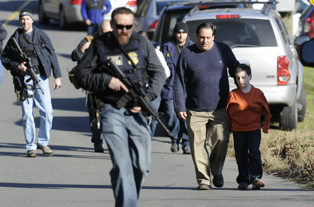 Connecticut School Shooting Parents leave a staging area after being reunited with their children following a shooting at the Sandy Hook Elementary School in Newtown, Conn., about 60 miles (96 kilometers) northeast of New York City, Friday, Dec. 14, 2012. An official with knowledge of Friday's shooting said 27 people were dead, including 18 children. It was the worst school shooting in the country's history.