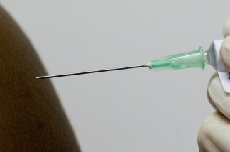 A medical syringe containing the African produced HIV vaccine is injected to a patient at the iEmavundleni Centre, in Crossroads, Cape Town, on July 28, 2009.