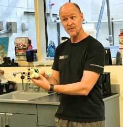 Chris Lowe with tracker Chris Lowe holding/explaining a shark tracking device