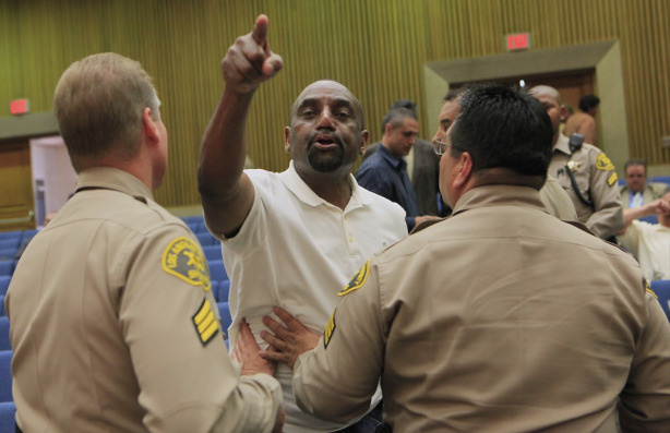 Rev. Jesse Lee Peterson, president and founder of The Brotherhood Organization of A New Destiny, middle, protests against Supervisor Mark Ridley-Thomas' vote, as he is asked to leave the hall by Los Angeles Sheriffs, after Los Angeles County Board of Supervisors voted 3-2 to join the city in its economic boycott of Arizona over its SB 1070 law targeting illegal immigrants, on Tuesday, Jun 1, 2010, in Los Angeles.