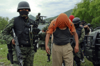 A group of people kidnapped by alleged drug-traffickers, are escorted during their freeing by members of the Mexican Army, in Sabinas Hidalgo, 99 km north of Monterrey, Nuevo Leon State, Mexico, on April 27, 2010.