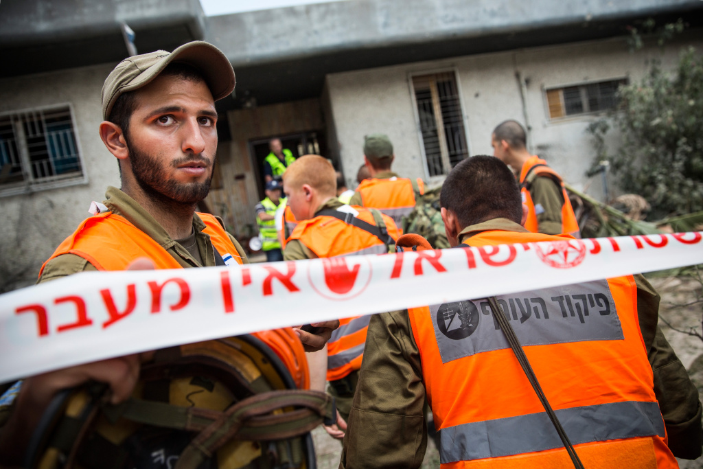 Tensions Remain High At Israeli Gaza Border Homefront Command members clean up rubble from a home after a Hamas rocket landed in the front yard on July 15, 2014 in Ashdod, Israel. As operation 'Protective Edge