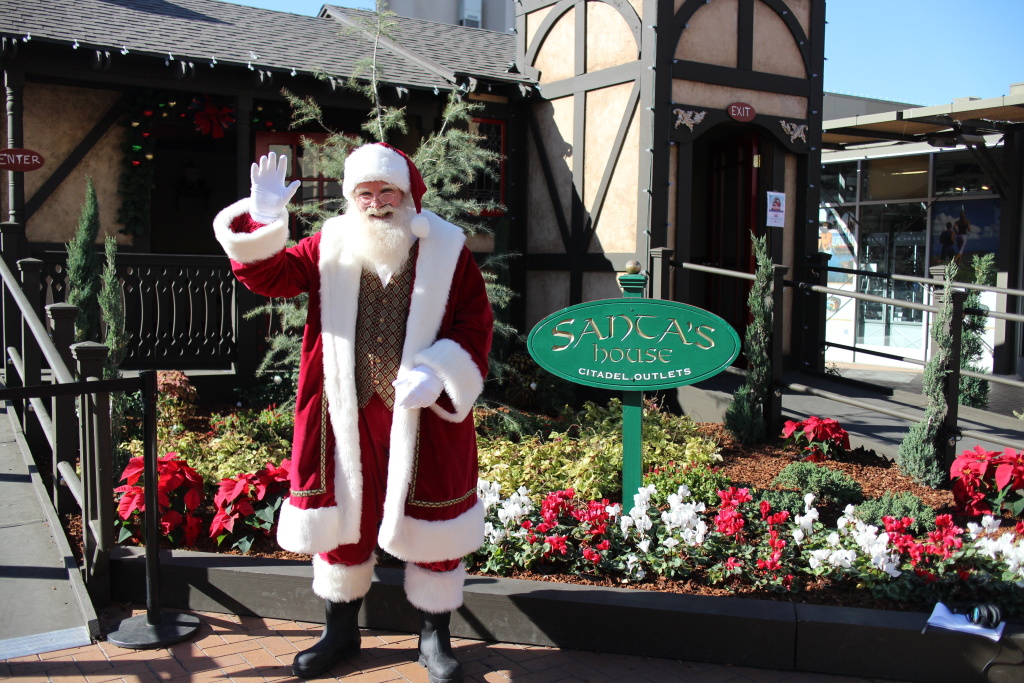 Santa stands outside of his house at the Citadel Outlets in Commerce for a Santa Cares event. Santa stands outside of his house at the Citadel Outlets in Commerce for a Santa Cares event.