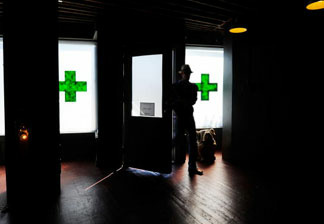 A client enters Sunset Junction medical marijuana dispensary in Los Angeles, California.