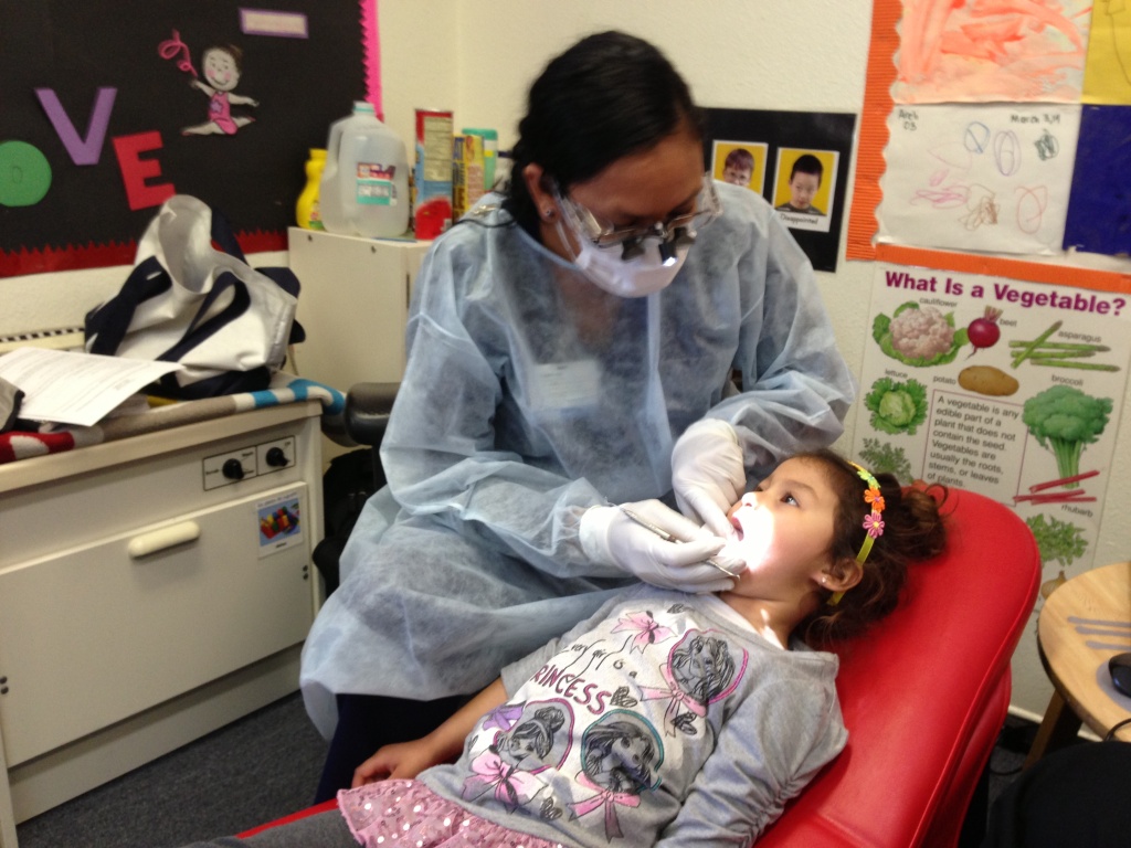 Virtual Dental Home 1 Mireya Rodriguez, a dental hygienist, administers temporary fillings to four-year-old Erika Ruiz. Hygienists aren't allowed to give temporary fillings, but Rodriguez is part of a pilot project testing whether hygienists might become the new front line for care for low-income children.