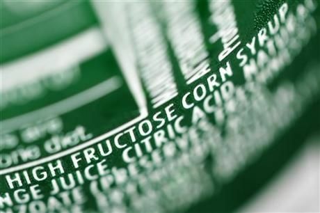 FILE - In this Sept. 15, 2011, file photo, high fructose corn syrup is listed as an ingredient on a can of soda in Philadelphia. Scientists have used imaging tests to show for the first time that fructose, a sugar that saturates the American diet, can trigger brain changes that may lead to overeating. The study, in the Journal of the American Medical Association on Tuesday, Jan. 1, 2013, is a small study and does not prove that fructose or its relative, high-fructose corn syrup, can cause obesity, but experts say it adds evidence they may play a role.