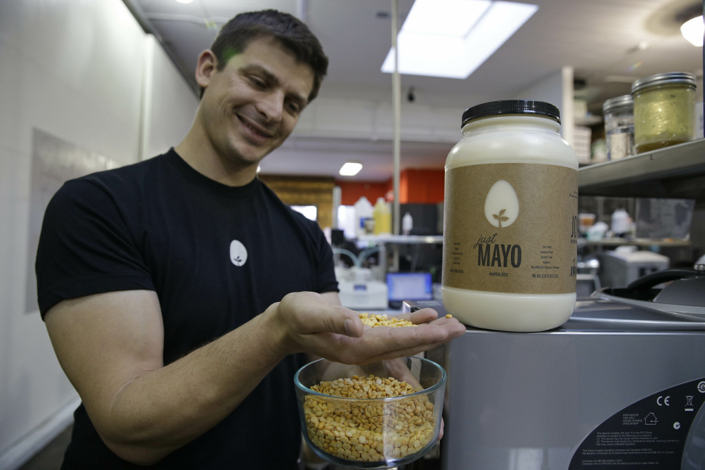Cracking the Egg In this photo taken Tuesday, Dec. 3, 2013, CEO Josh Tetrick holds a species of yellow pea used to make Just Mayo, a plant-based mayonnaise, at Hampton Creek Foods in San Francisco. Can plants replace eggs? A San Francisco startup backed by Bill Gates believes they can. Hampton Creek Foods is scouring the planet for plants that can replace chicken eggs in everything from cookies to omelets to French toast. Funded by prominent Silicon Valley investors, the upstart seeks to disrupt a global egg industry that backers say wastes energy, pollutes the environment, causes disease outbreaks and confines chickens to tiny spaces. (AP Photo/Eric Risberg)