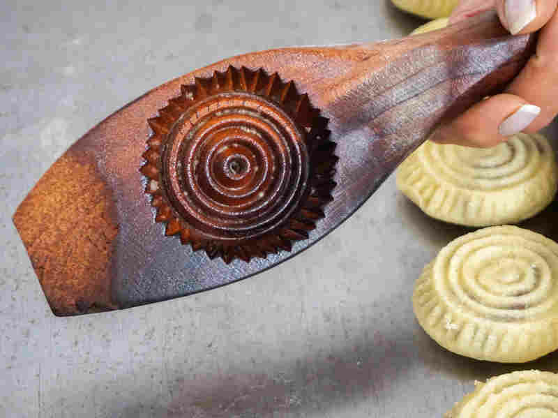 Traditionally carved wooden molds are used to give shape and form to the maamoul cookies. Traditionally carved wooden molds are used to give shape and form to the maamoul cookies.