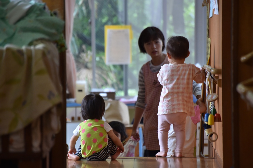 JAPAN-WOMAN-SOCIAL-ECONOMY This picture taken on June 29, 2016 shows an employee of an official nursery school taking care of young children in Yokohama, Japan.