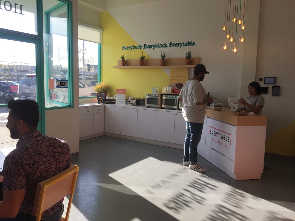 Everytable employee Jailene Miranda helps a customer check out at the South L.A. location of Everytable. Miranda grew up in South L.A. and is studying health sciences at California State University, Long Beach. She said she had to be part of Everytable after she walked in about a year ago and heard about its mission. “This is where I grew up and we need this,” she said. Everytable employee Jailene Miranda helps a customer check out at the South L.A. location of Everytable. Miranda grew up in South L.A. and is studying health sciences at California State University, Long Beach. She said she had to be part of Everytable after she walked in about a year ago and heard about its mission. “This is where I grew up and we need this,” she said.