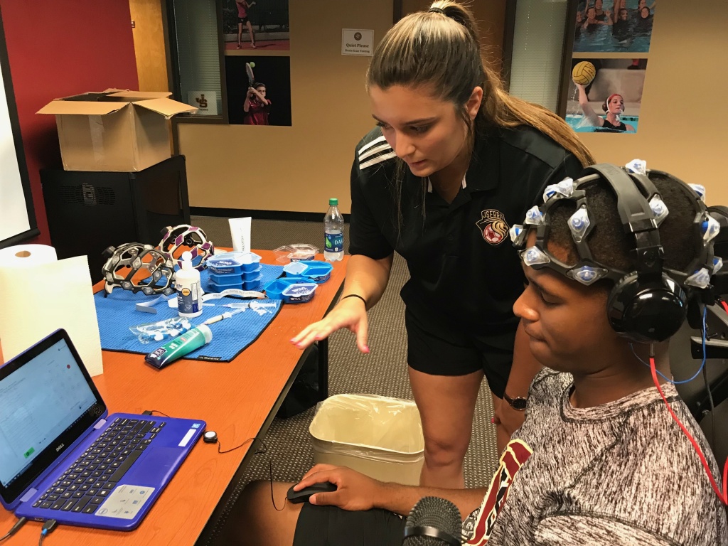 Munir McClain, 17, an incoming senior at JSerra High School, submits to a baseline brain scan administered by Erin Laswell. Munir McClain, 17, an incoming senior at JSerra High School, submits to a baseline brain scan administered by Erin Laswell.
