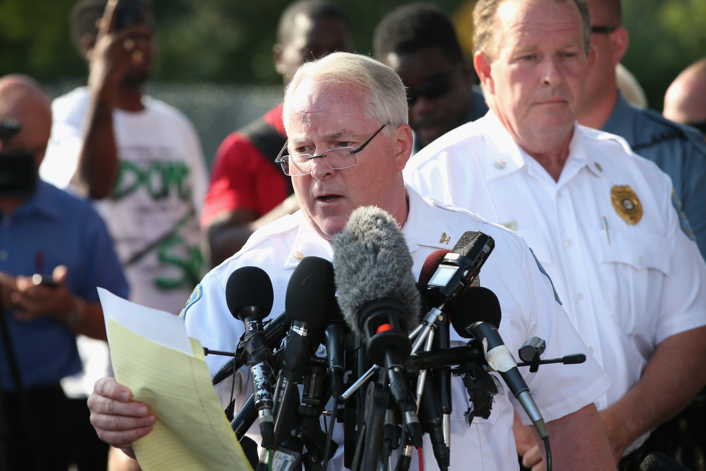 Outrage In Missouri Town After Police Shooting Of 18-Yr-Old Man Standing in the parking lot of a gas station which was burned during rioting, Ferguson Police Chief Thomas Jackson announces the name of the Ferguson police officer responsible for the August 9, shooting death of teenager Michael Brown on August 15, 2014 in Ferguson, Missouri. The officer was identified as Darren Wilson, a six year veteran of the police department. Brown's killing sparked several days of violent protests in the city.