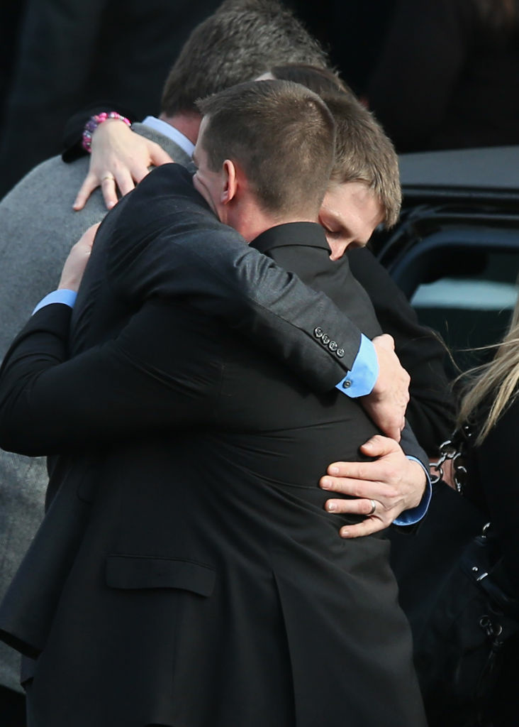 Family and friends embrace after the funeral for shooting victim Jessica Rekos, 6, at the St. Rose of Lima Catholic church on Tuesday in Newtown, Connecticut. Funeral services continue on Wednesday.